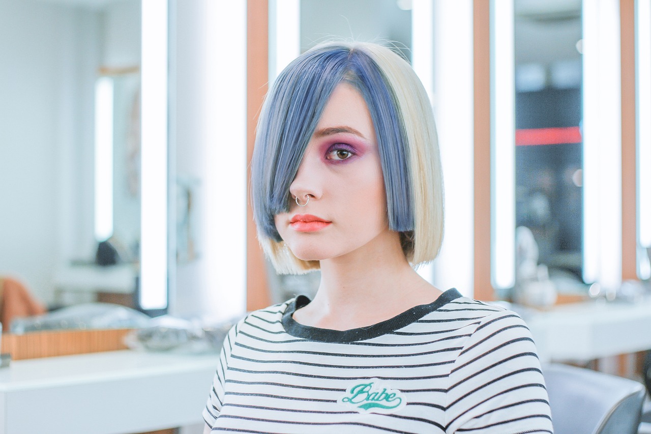 Woman with a blue and blonde bob in a salon